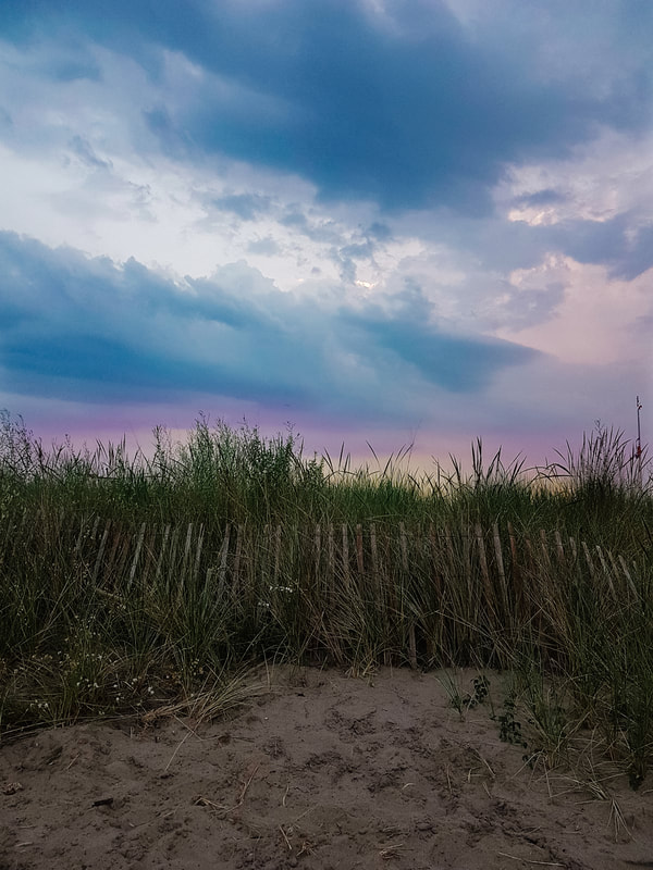 Sunset over the grassy dunes at Port Stanley