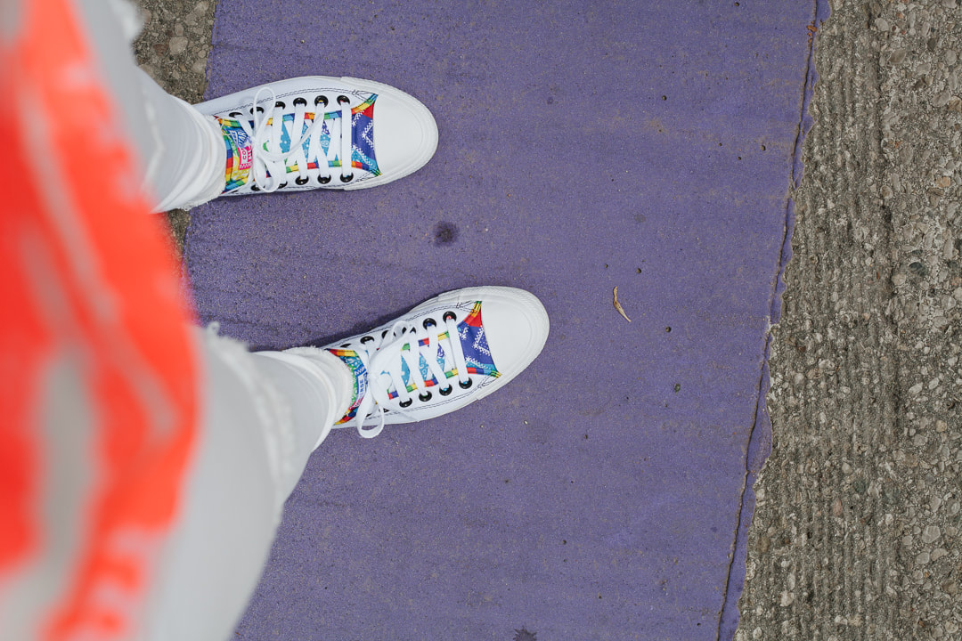 Pride converse shoes along the pride crosswalk